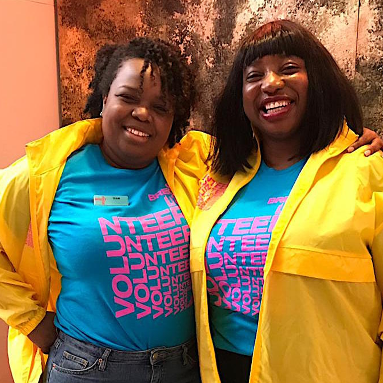 2 volunteers smiling